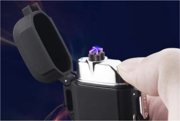 Thumb pressing the button on the Black Lighter to light the dual plasma arc
